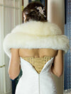 model in wedding gown showing the back lace up view of a beige mesh corset with beige manufacturers laces