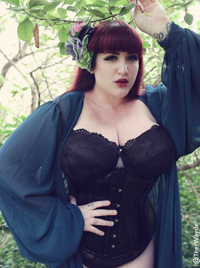 Teer Wayde in a black PVC 426 longline corset and robe sultry eyes